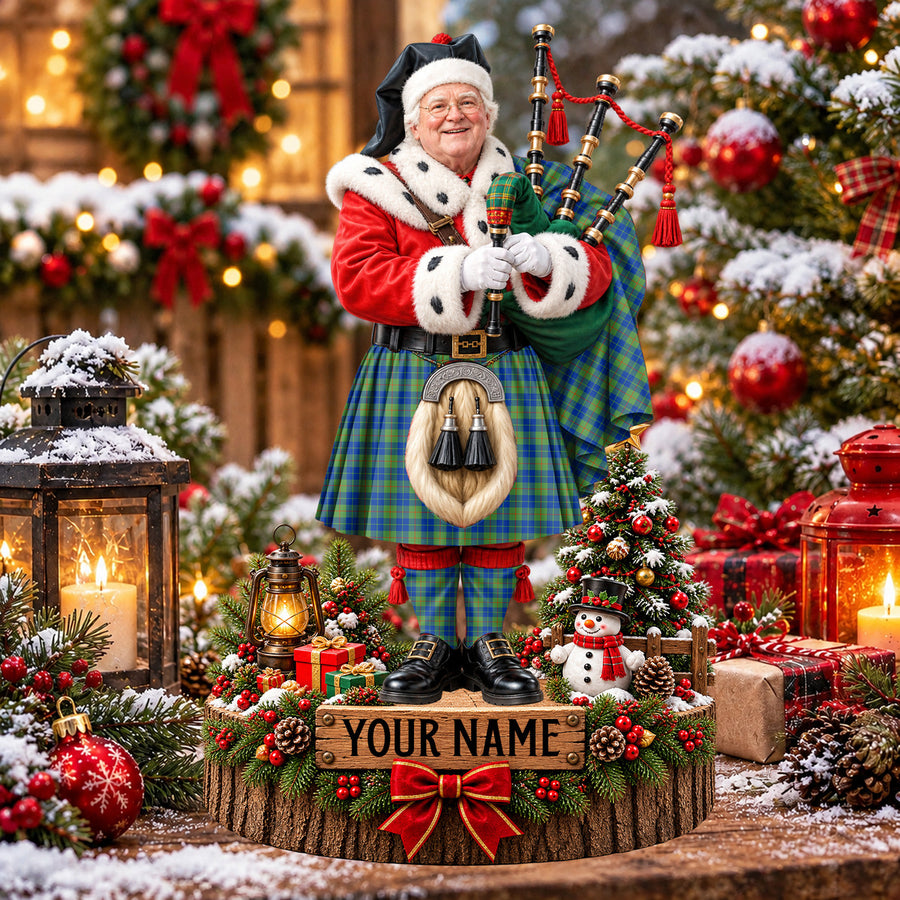 Personalized Christmas piper plaque in the Barclay Hunting Ancient tartan, standing on a snowy log base with a name plaque