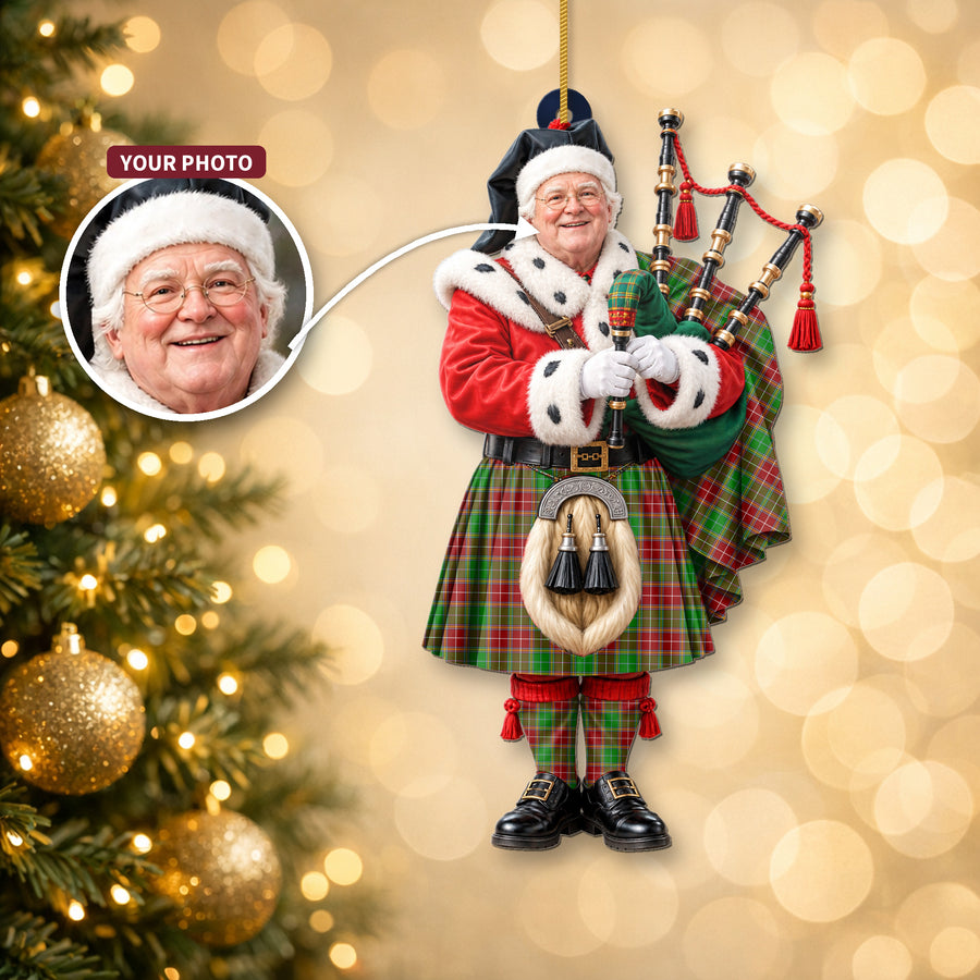 Christmas piper ornament in the Baxter Modern tartan hanging on a Christmas tree, with the customer photo used for the face