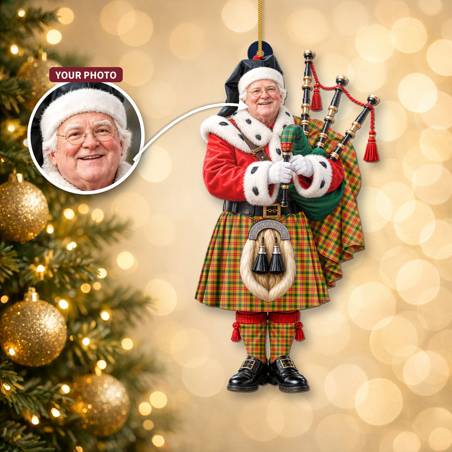 Christmas piper ornament in the Baxter tartan hanging on a Christmas tree, with the customer photo used for the face
