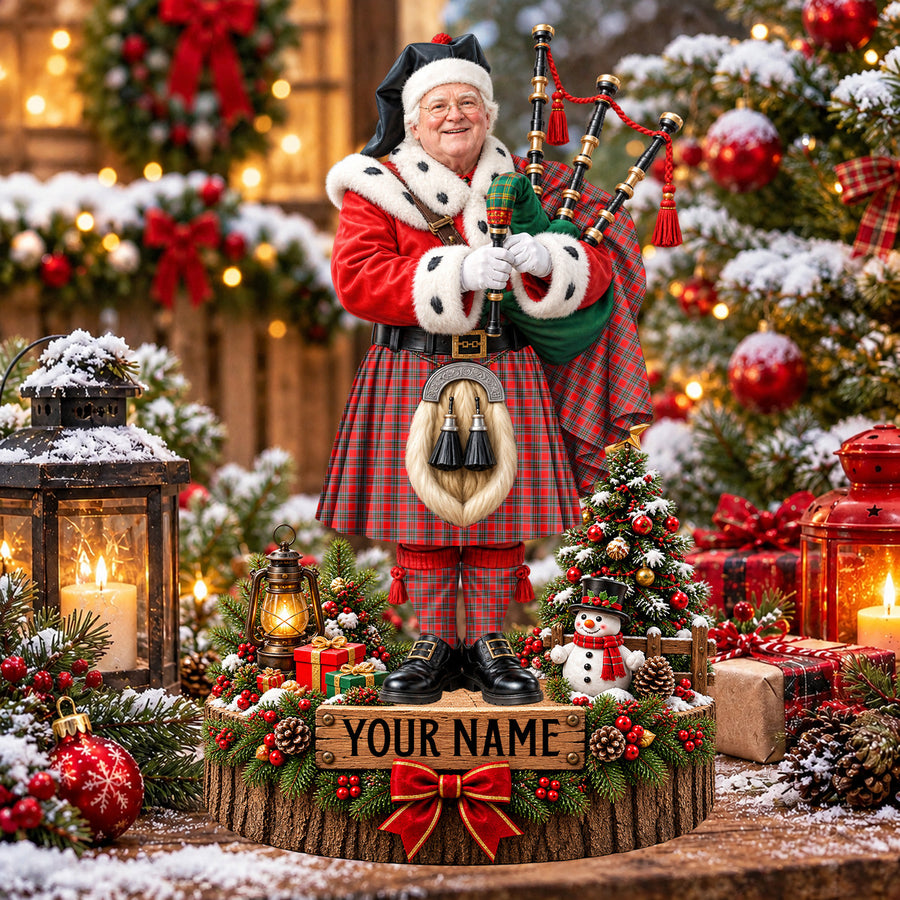 Personalized Christmas piper plaque in the Binning tartan, standing on a snowy log base with a name plaque