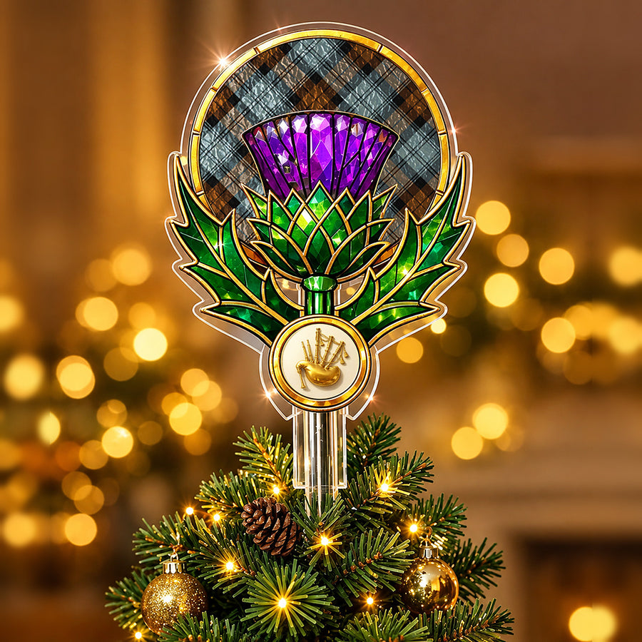 Stained-glass style thistle Christmas tree topper with a gold bagpipe emblem and the Blackwatch Weathered tartan behind the thistle
