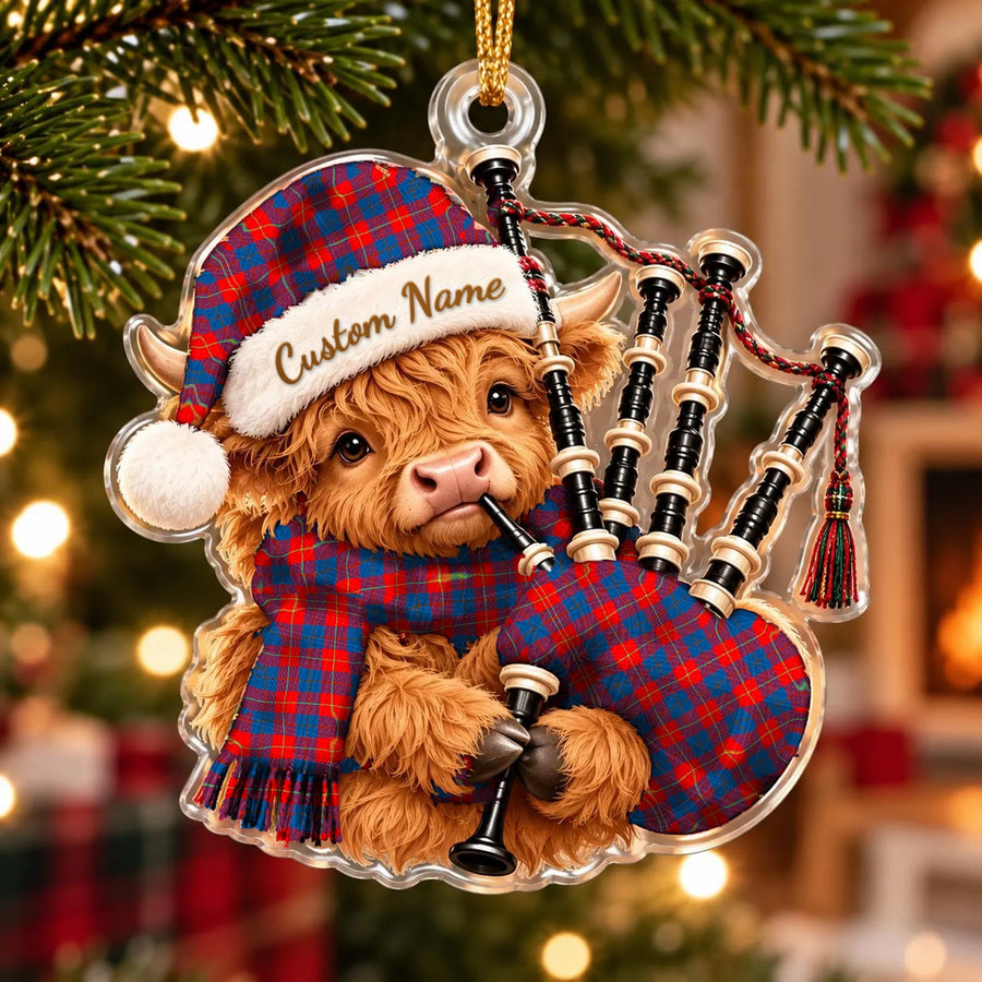 Acrylic Highland cow calf ornament playing the bagpipes, in a Blane 2 tartan Santa hat, scarf and pipe bag, with a custom name on the hat