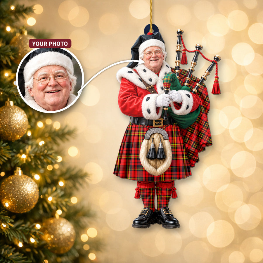 Christmas piper ornament in the Brodie Modern tartan hanging on a Christmas tree, with the customer photo used for the face