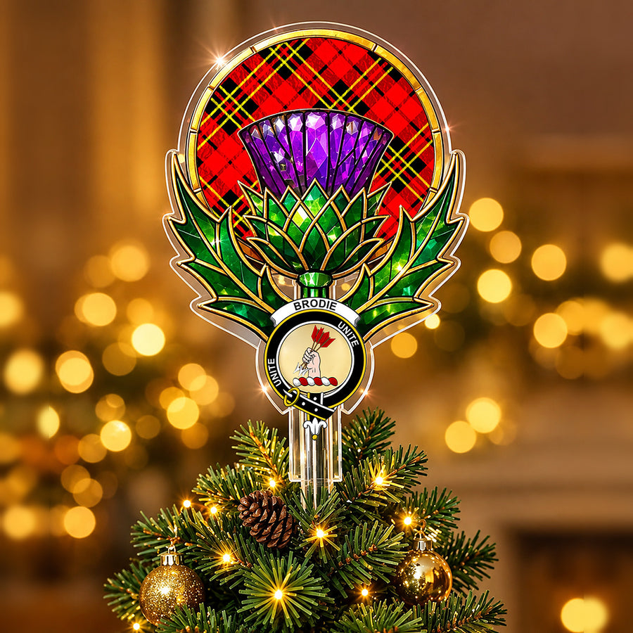 Clan Brodie crest in the centre of a stained-glass style thistle Christmas tree topper with the Brodie Modern tartan behind the thistle