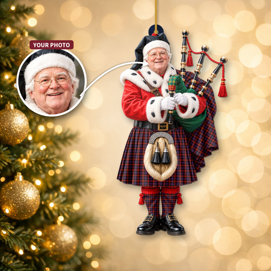 Christmas piper ornament in the Broun tartan hanging on a Christmas tree, with the customer photo used for the face