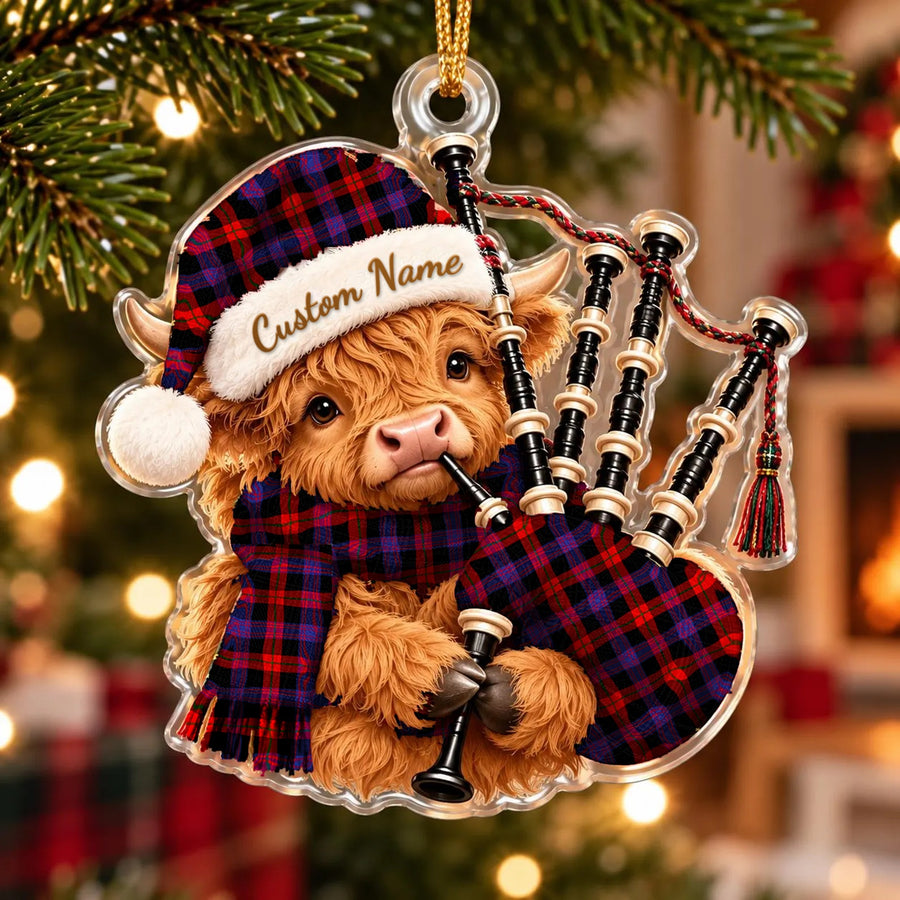 Acrylic Highland cow calf ornament playing the bagpipes, in a Brown Modern tartan Santa hat, scarf and pipe bag, with a custom name on the hat