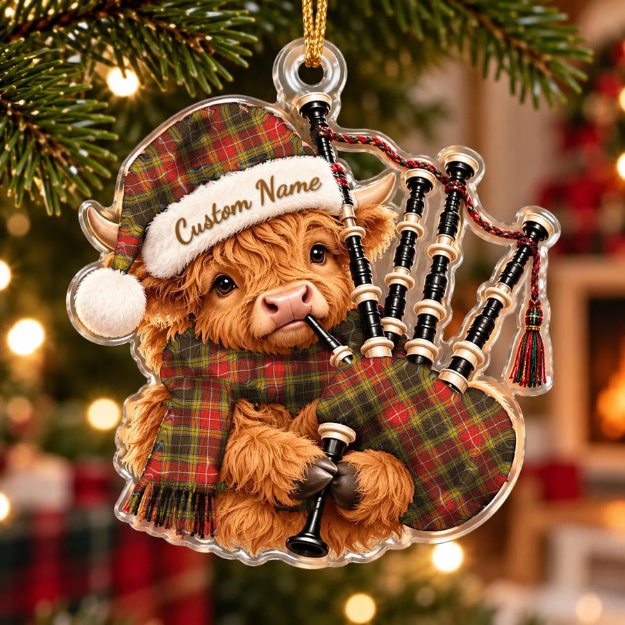 Acrylic Highland cow calf ornament playing the bagpipes, in a Buchanan Old Set Weathered tartan Santa hat, scarf and pipe bag, with a custom name on the hat