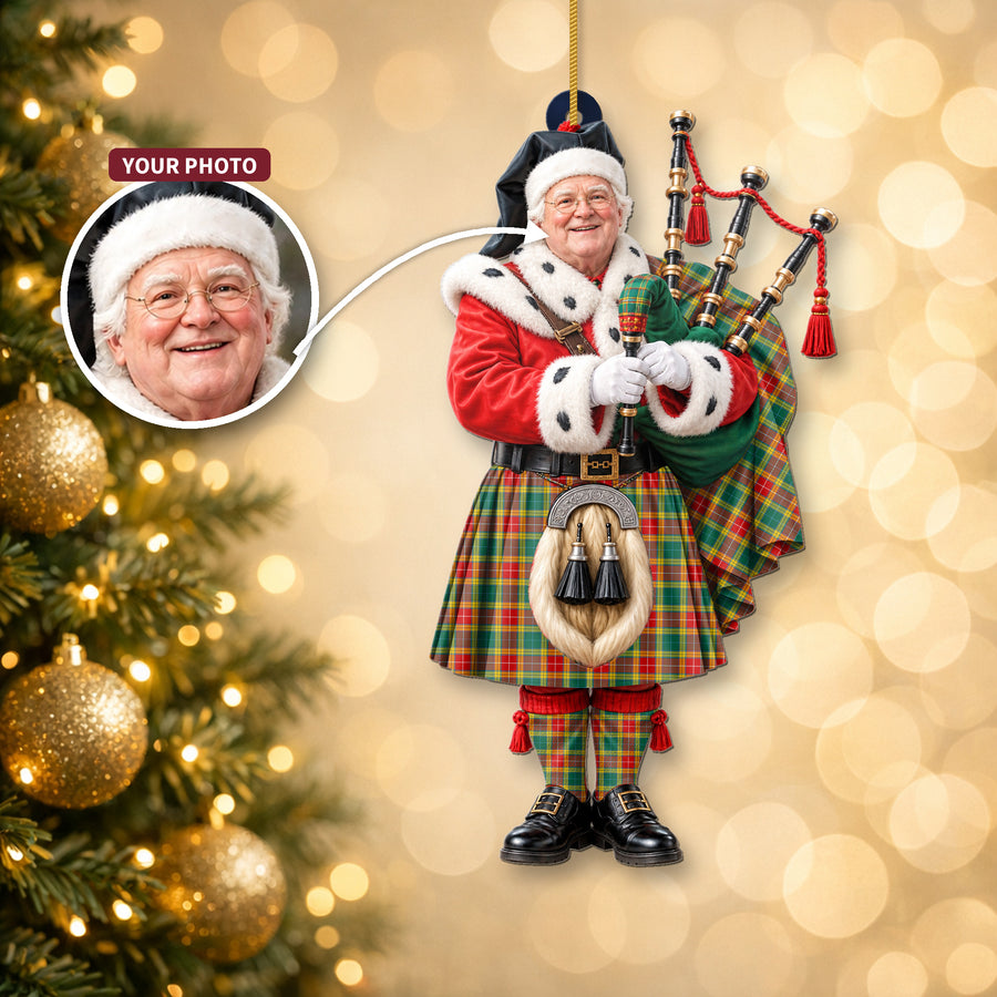 Christmas piper ornament in the Buchanan Old Sett tartan hanging on a Christmas tree, with the customer photo used for the face
