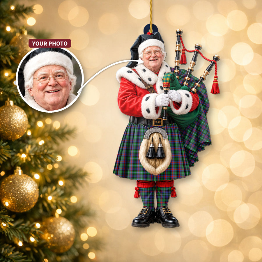 Christmas piper ornament in the Calder tartan hanging on a Christmas tree, with the customer photo used for the face
