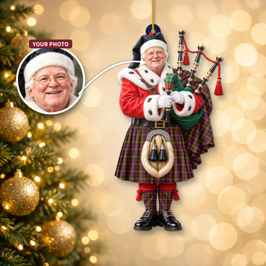 Christmas piper ornament in the Carnegie Modern tartan hanging on a Christmas tree, with the customer photo used for the face