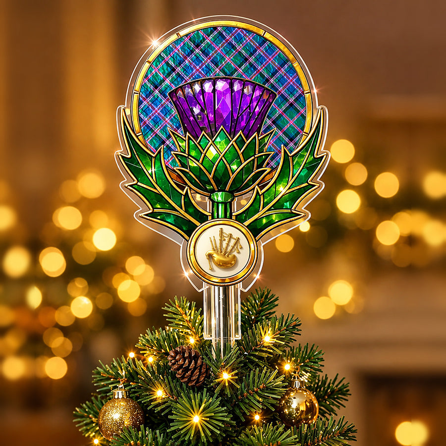 Stained-glass style thistle Christmas tree topper with a gold bagpipe emblem and the Cooper Ancient tartan behind the thistle