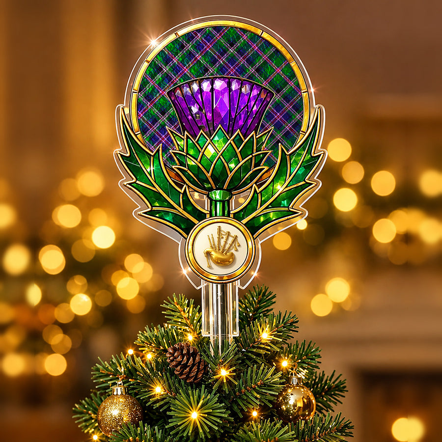 Stained-glass style thistle Christmas tree topper with a gold bagpipe emblem and the Cooper Modern tartan behind the thistle