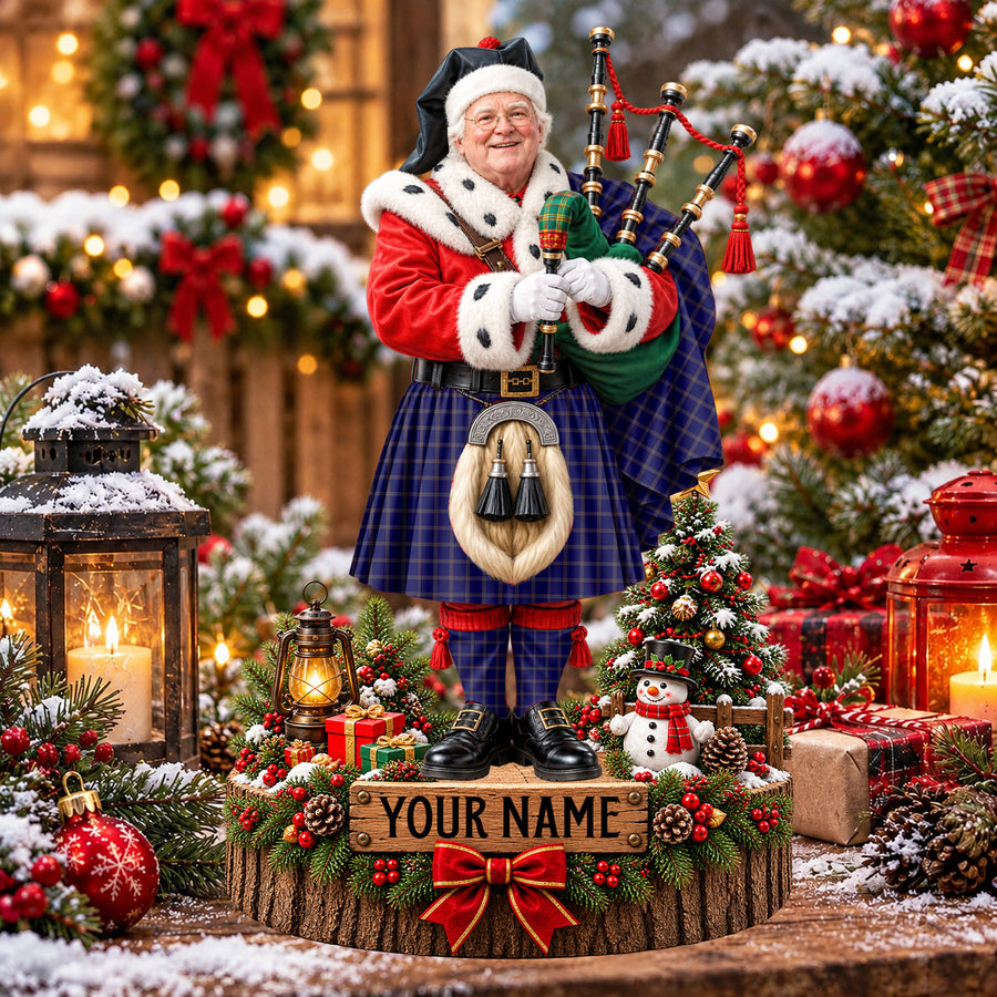 Personalized Christmas piper plaque in the Crichton tartan, standing on a snowy log base with a name plaque