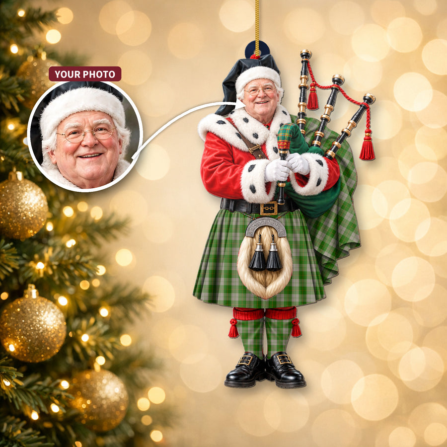 Christmas piper ornament in the Cunningham Dress Green Dancers tartan hanging on a Christmas tree, with the customer photo used for the face
