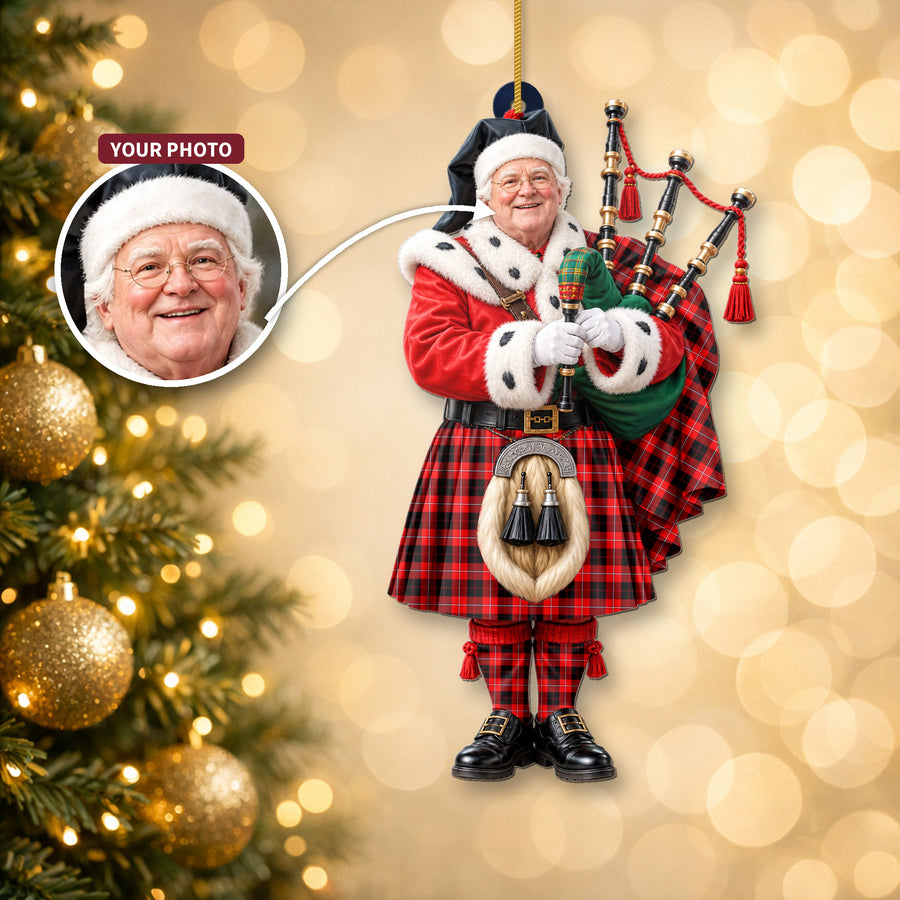 Christmas piper ornament in the Cunningham Modern tartan hanging on a Christmas tree, with the customer photo used for the face