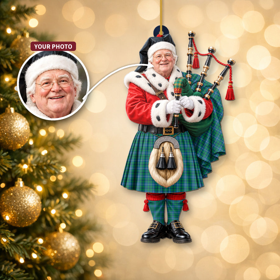 Christmas piper ornament in the Douglas Ancient tartan hanging on a Christmas tree, with the customer photo used for the face