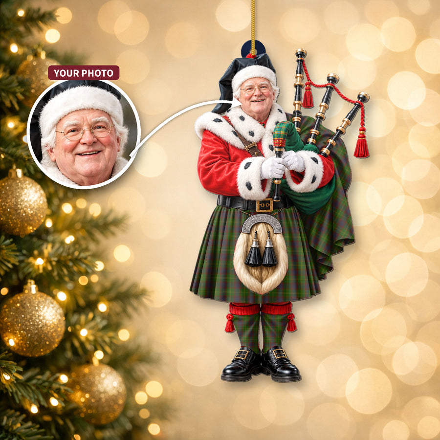 Christmas piper ornament in the Durie tartan hanging on a Christmas tree, with the customer photo used for the face