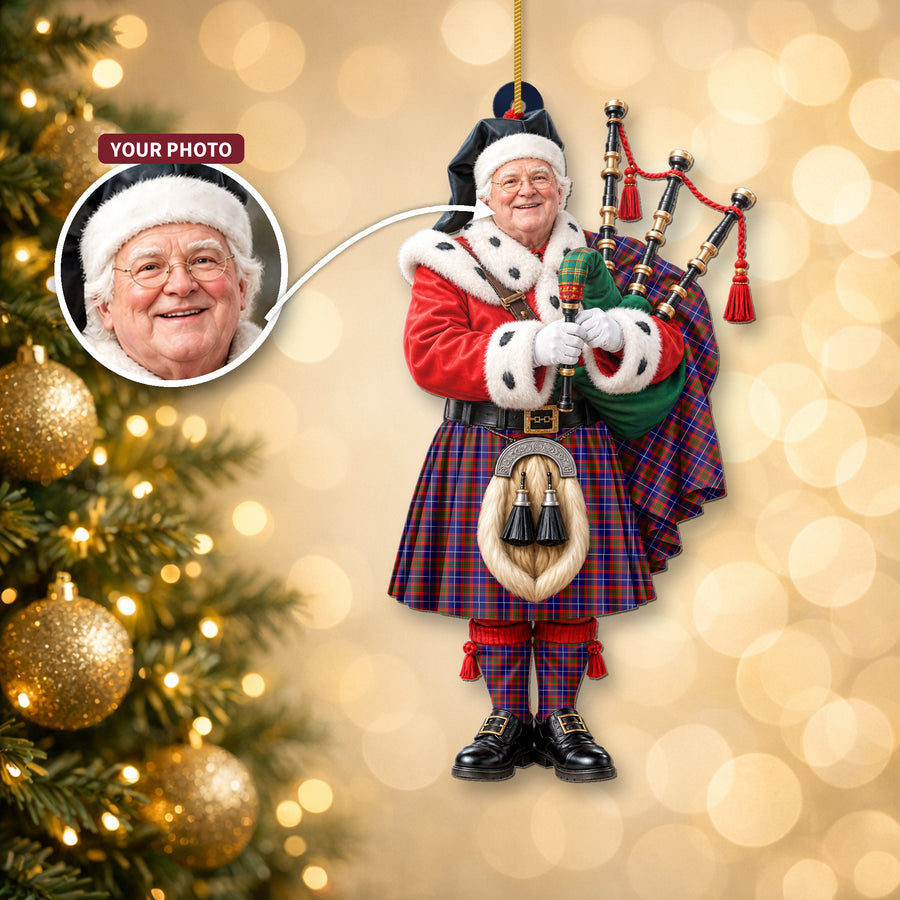 Christmas piper ornament in the Edinburgh District tartan hanging on a Christmas tree, with the customer photo used for the face