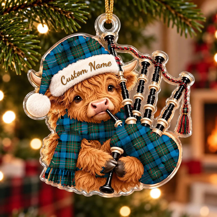 Acrylic Highland cow calf ornament playing the bagpipes, in a Fergusson Ancient tartan Santa hat, scarf and pipe bag, with a custom name on the hat