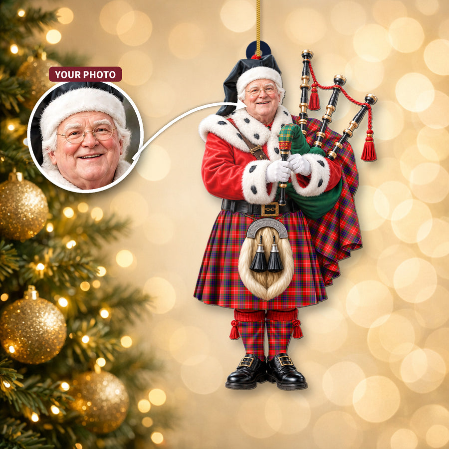 Christmas piper ornament in the Fraser Modern tartan hanging on a Christmas tree, with the customer photo used for the face