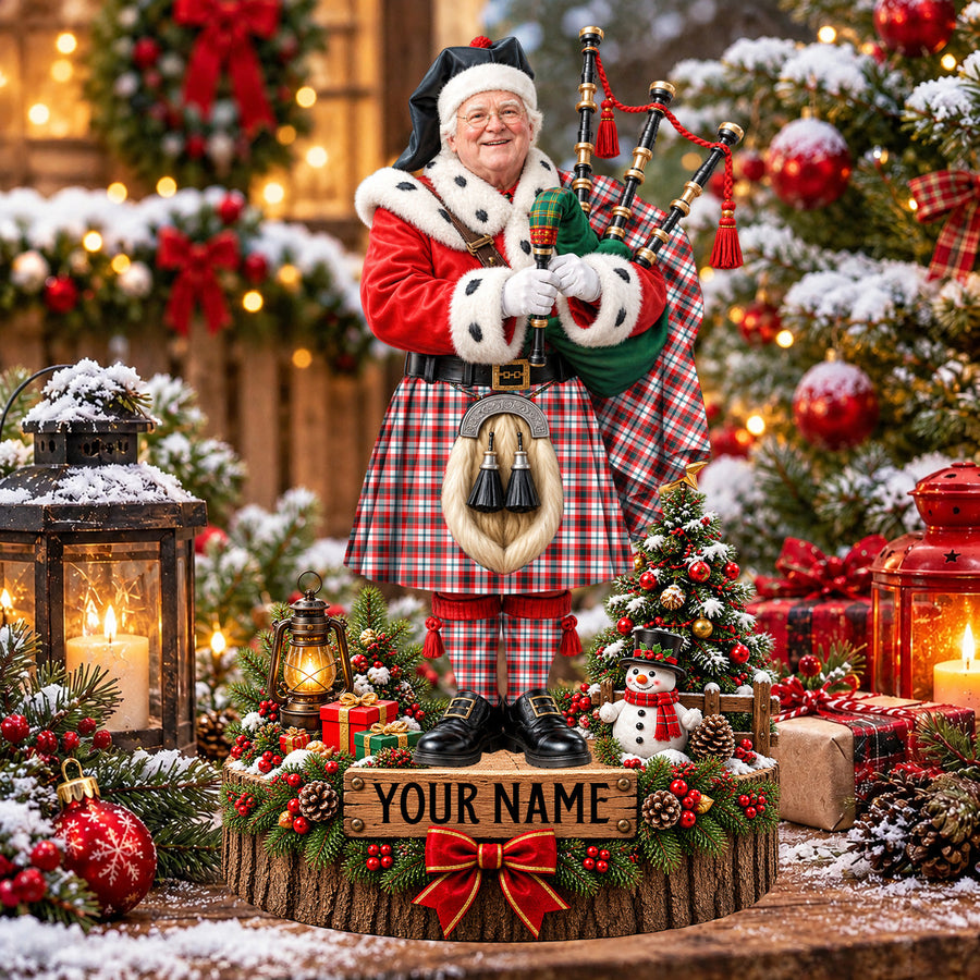 Personalized Christmas piper plaque in the Glasgow District tartan, standing on a snowy log base with a name plaque