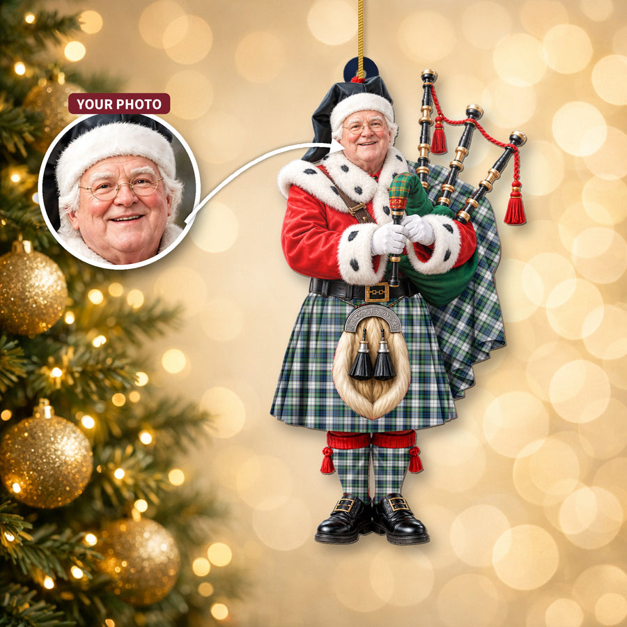 Christmas piper ornament in the Gordon Dress Ancient tartan hanging on a Christmas tree, with the customer photo used for the face