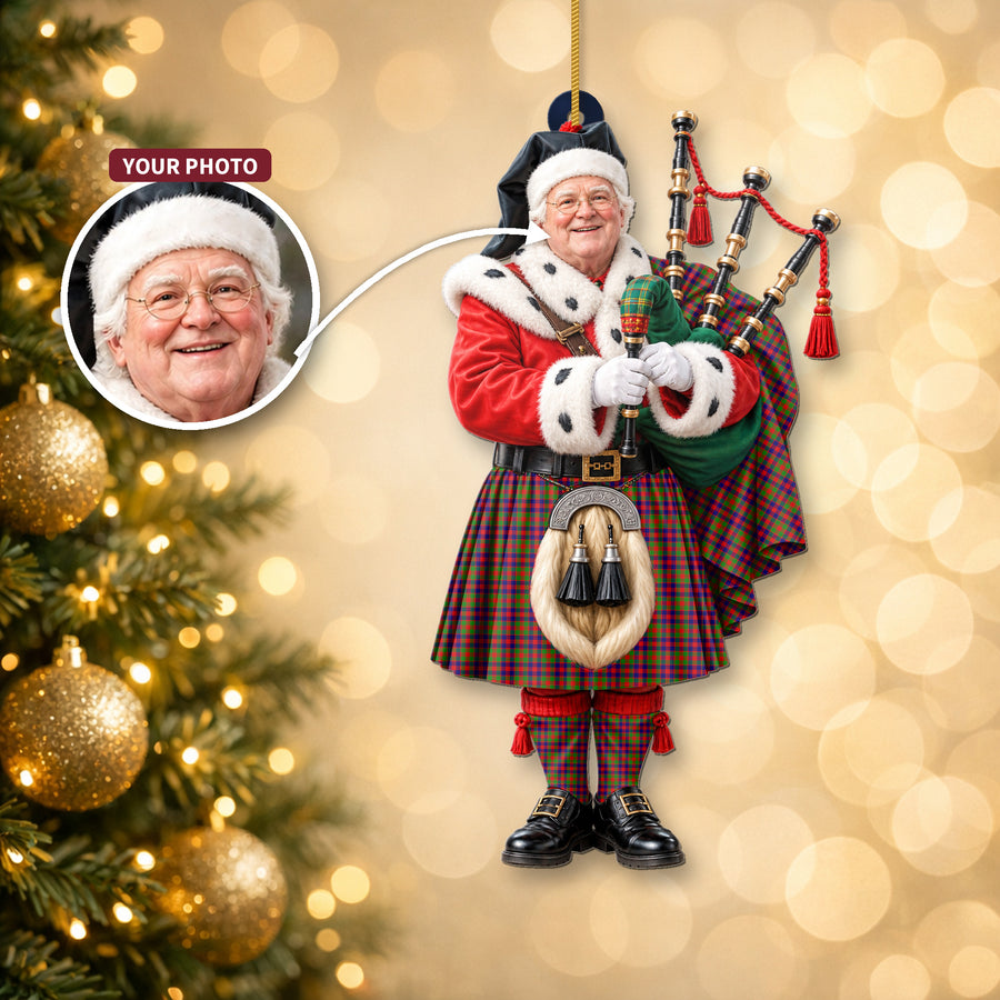 Christmas piper ornament in the Gow (or McGouan) tartan hanging on a Christmas tree, with the customer photo used for the face