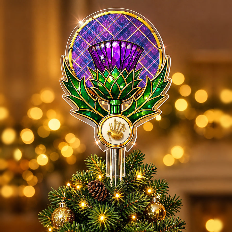 Stained-glass style thistle Christmas tree topper with a gold bagpipe emblem and the Gretna Green tartan behind the thistle