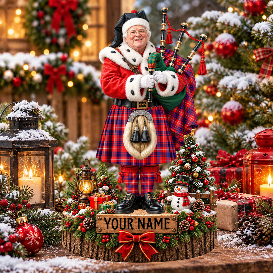 Personalized Christmas piper plaque in the Hamilton Modern tartan, standing on a snowy log base with a name plaque