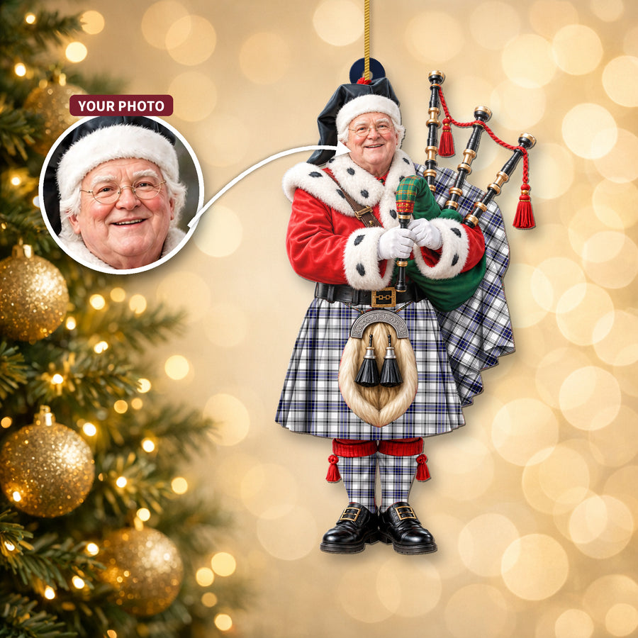 Christmas piper ornament in the Hannay tartan hanging on a Christmas tree, with the customer photo used for the face