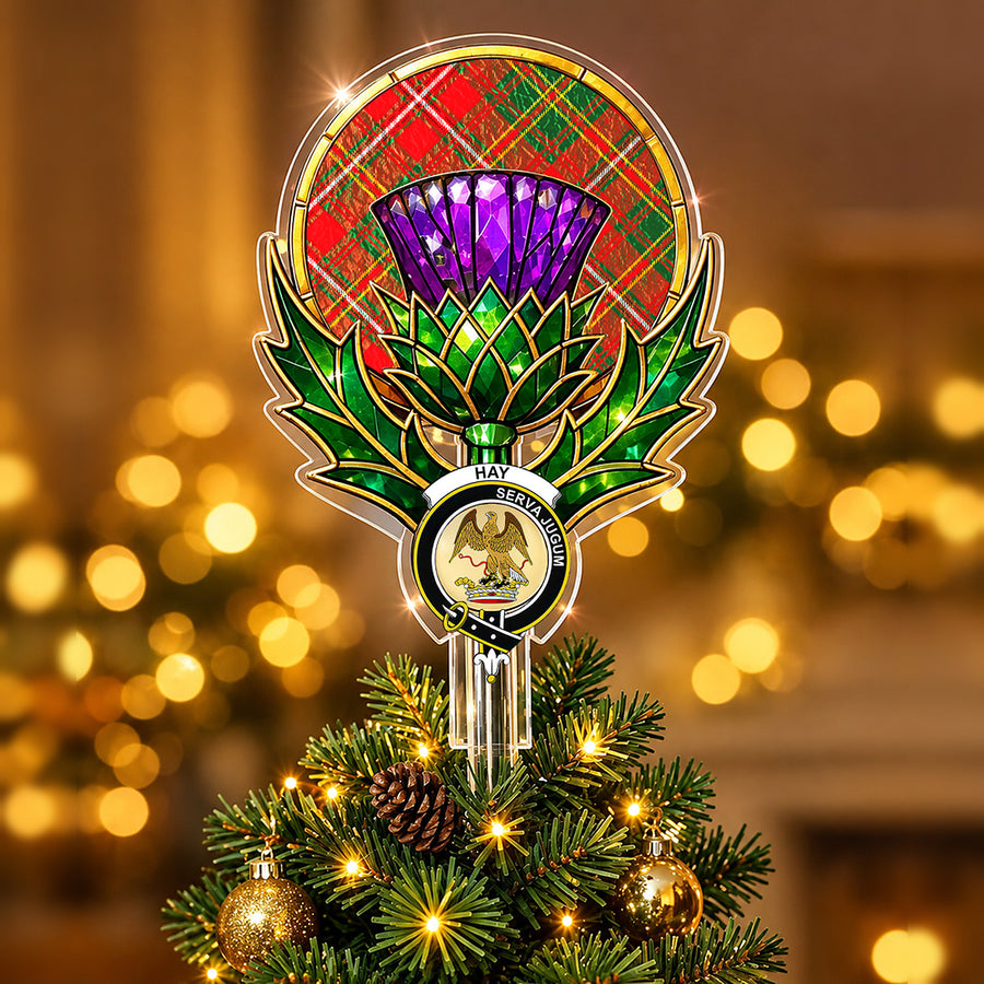 Clan Hay crest in the centre of a stained-glass style thistle Christmas tree topper with the Hay Modern tartan behind the thistle
