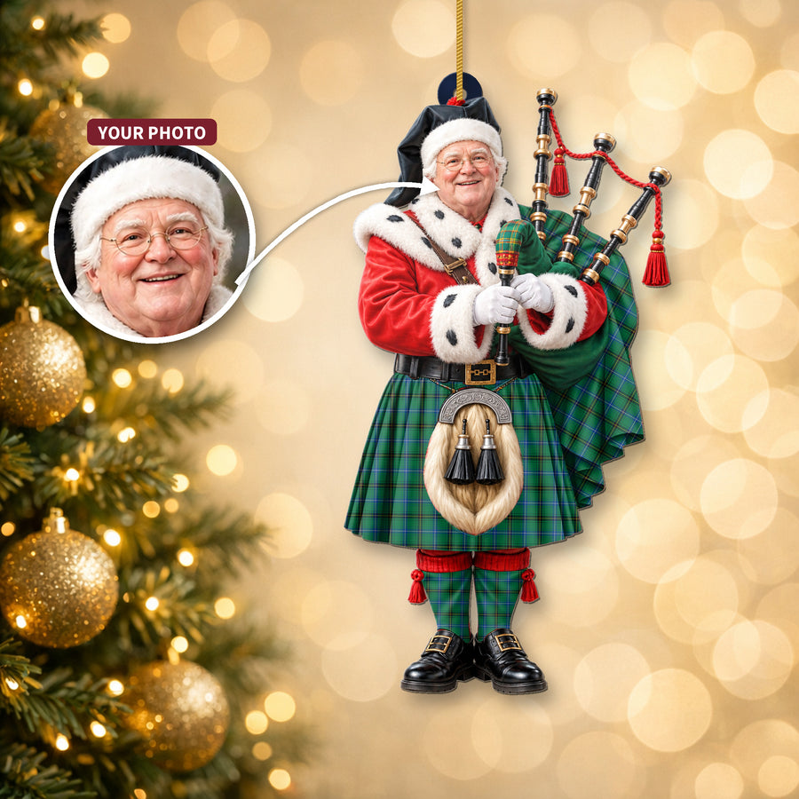 Christmas piper ornament in the Henderson Ancient tartan hanging on a Christmas tree, with the customer photo used for the face