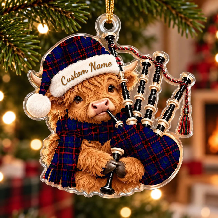 Acrylic Highland cow calf ornament playing the bagpipes, in a Home Modern tartan Santa hat, scarf and pipe bag, with a custom name on the hat