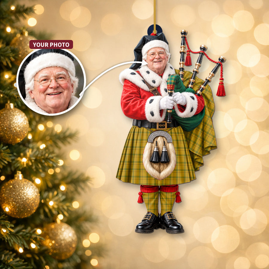 Christmas piper ornament in the Houston tartan hanging on a Christmas tree, with the customer photo used for the face