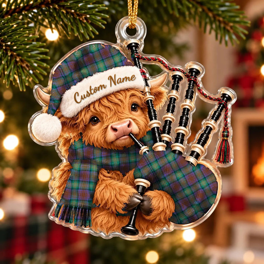 Acrylic Highland cow calf ornament playing the bagpipes, in a Isle of Skye tartan Santa hat, scarf and pipe bag, with a custom name on the hat