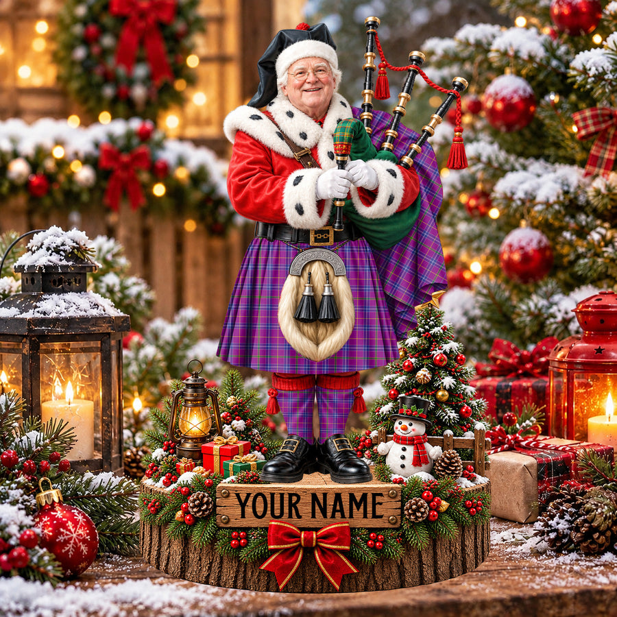 Personalized Christmas piper plaque in the Jackson tartan, standing on a snowy log base with a name plaque