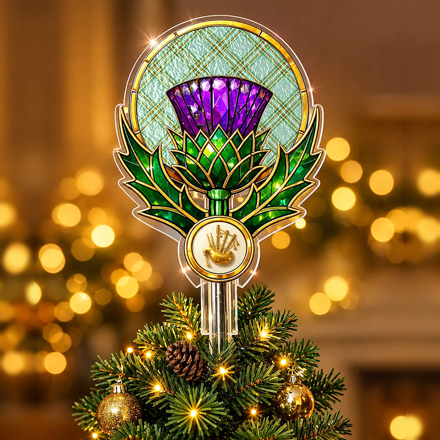 Stained-glass style thistle Christmas tree topper with a gold bagpipe emblem and the Kelly Dress tartan behind the thistle