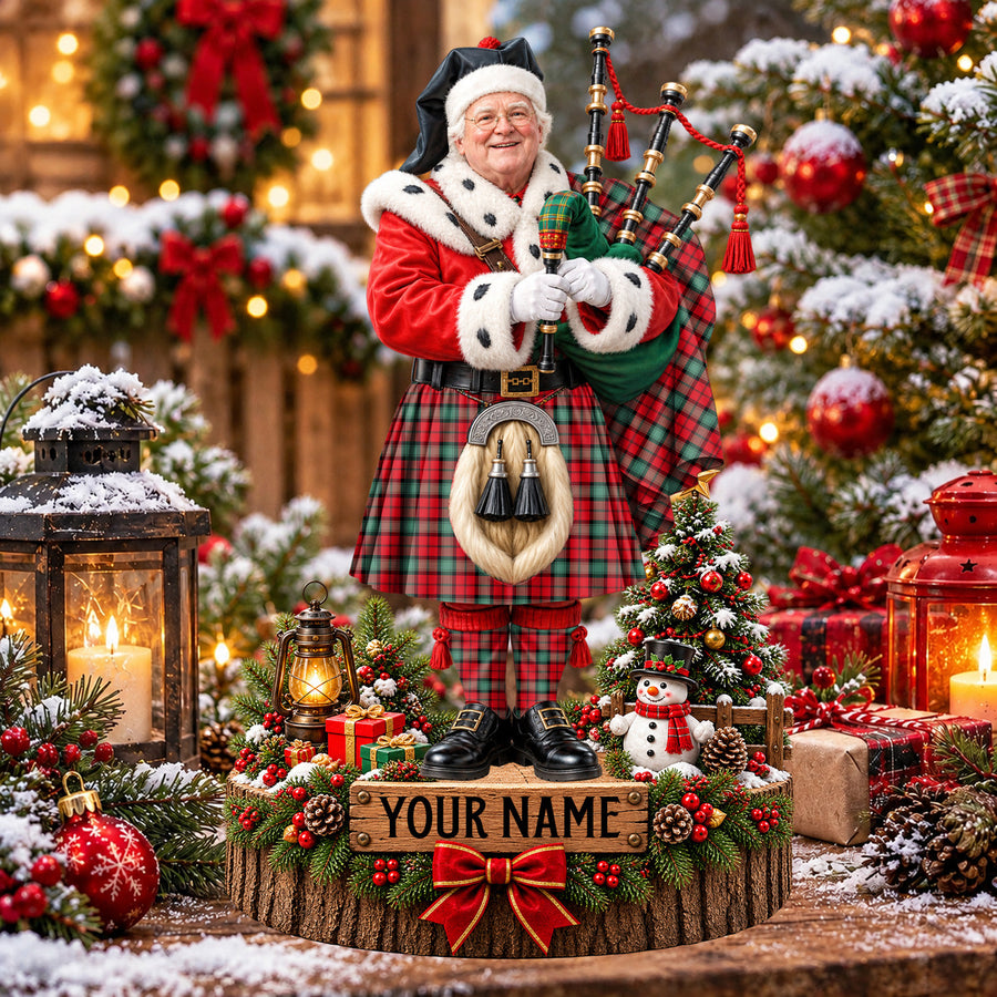 Personalized Christmas piper plaque in the Kerr Ancient tartan, standing on a snowy log base with a name plaque