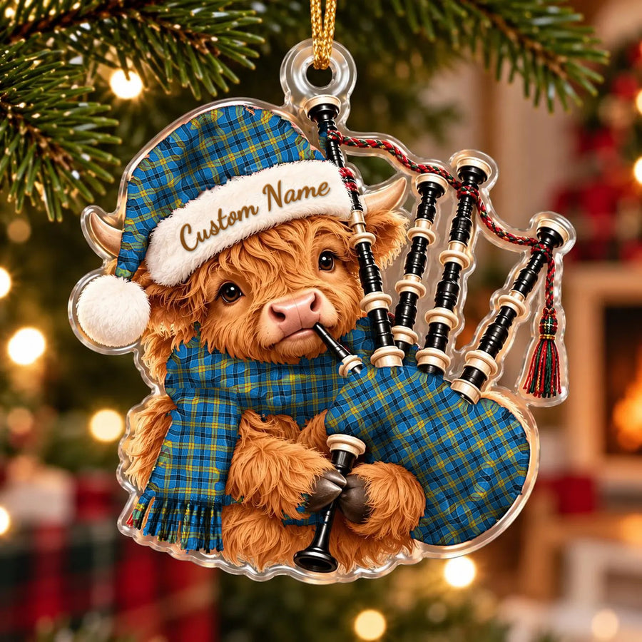 Acrylic Highland cow calf ornament playing the bagpipes, in a Laing tartan Santa hat, scarf and pipe bag, with a custom name on the hat