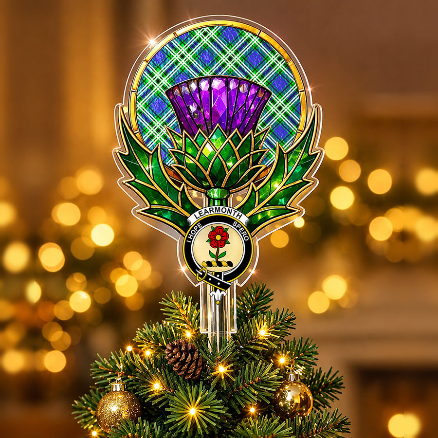 Clan Learmonth crest in the centre of a stained-glass style thistle Christmas tree topper with the Learmonth tartan behind the thistle