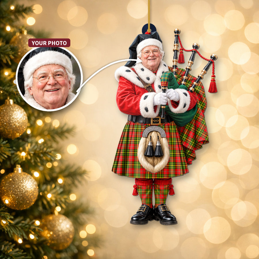 Christmas piper ornament in the Leask tartan hanging on a Christmas tree, with the customer photo used for the face