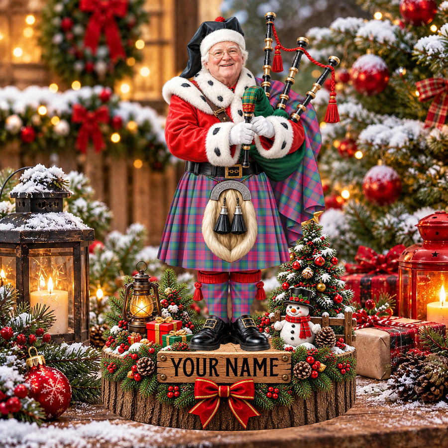 Personalized Christmas piper plaque in the Lindsay Ancient tartan, standing on a snowy log base with a name plaque