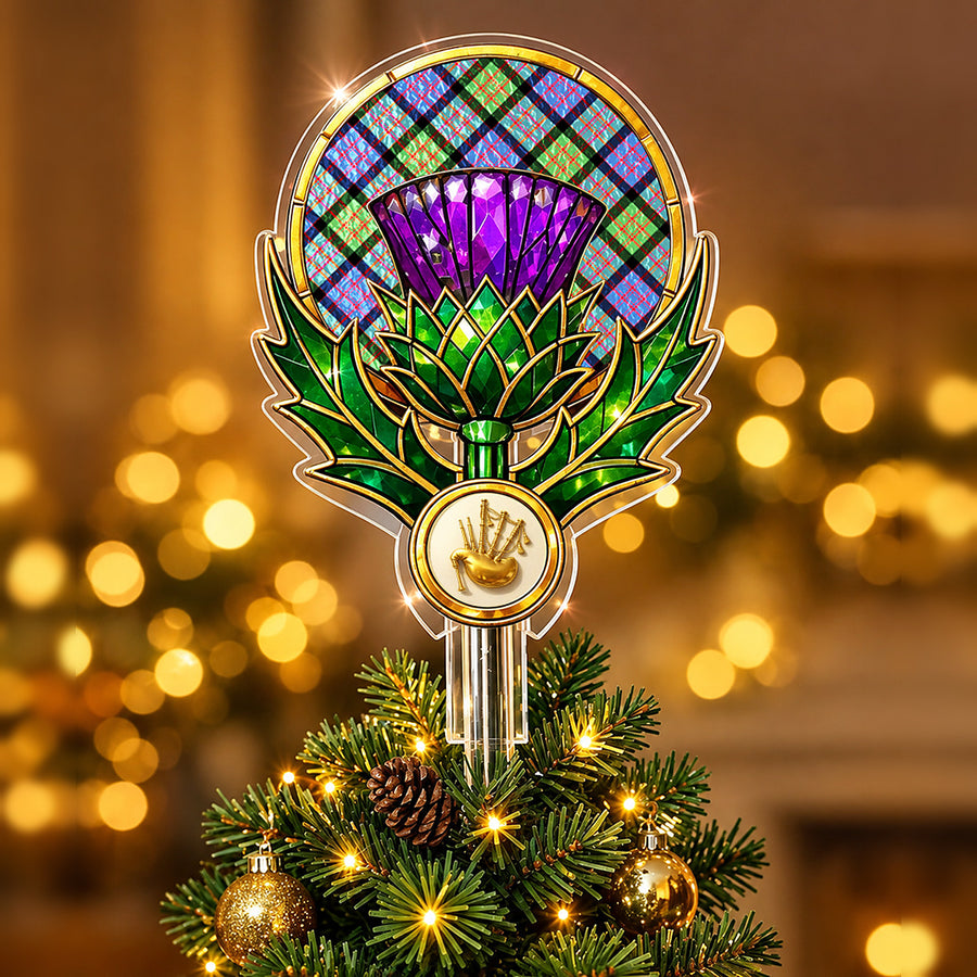 Stained-glass style thistle Christmas tree topper with a gold bagpipe emblem and the MacDonald Ancient tartan behind the thistle