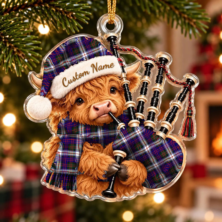 Acrylic Highland cow calf ornament playing the bagpipes, in a MacDonald Dress Modern tartan Santa hat, scarf and pipe bag, with a custom name on the hat