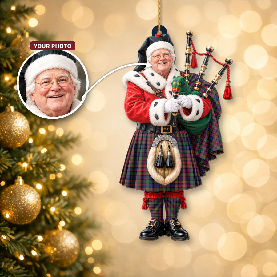 Christmas piper ornament in the MacDonald Modern tartan hanging on a Christmas tree, with the customer photo used for the face