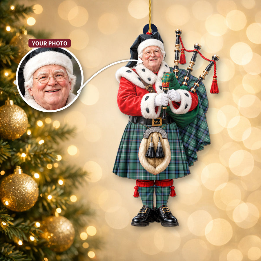 Christmas piper ornament in the MacDonald of the Isles Hunting Ancient tartan hanging on a Christmas tree, with the customer photo used for the face