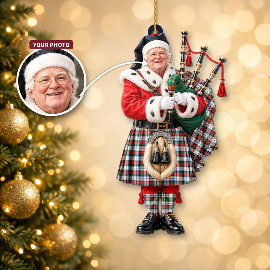 Christmas piper ornament in the MacDuff Dress Modern tartan hanging on a Christmas tree, with the customer photo used for the face