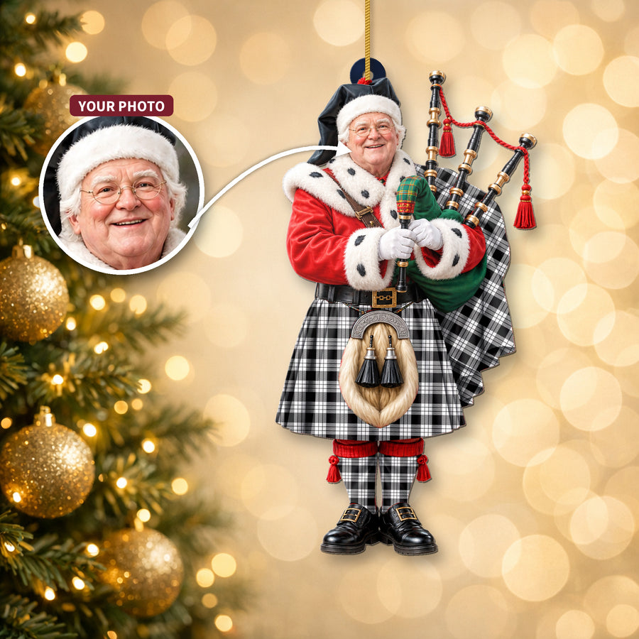 Christmas piper ornament in the MacFarlane Black & White tartan hanging on a Christmas tree, with the customer photo used for the face