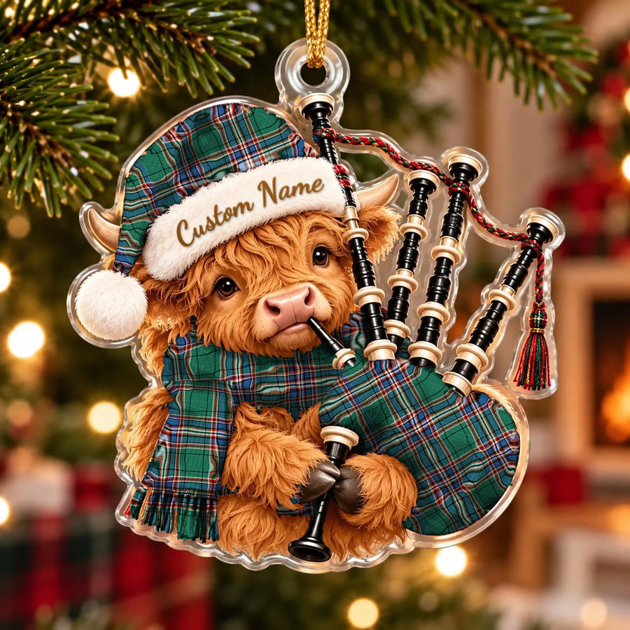Acrylic Highland cow calf ornament playing the bagpipes, in a MacFarlane Hunting Ancient tartan Santa hat, scarf and pipe bag, with a custom name on the hat
