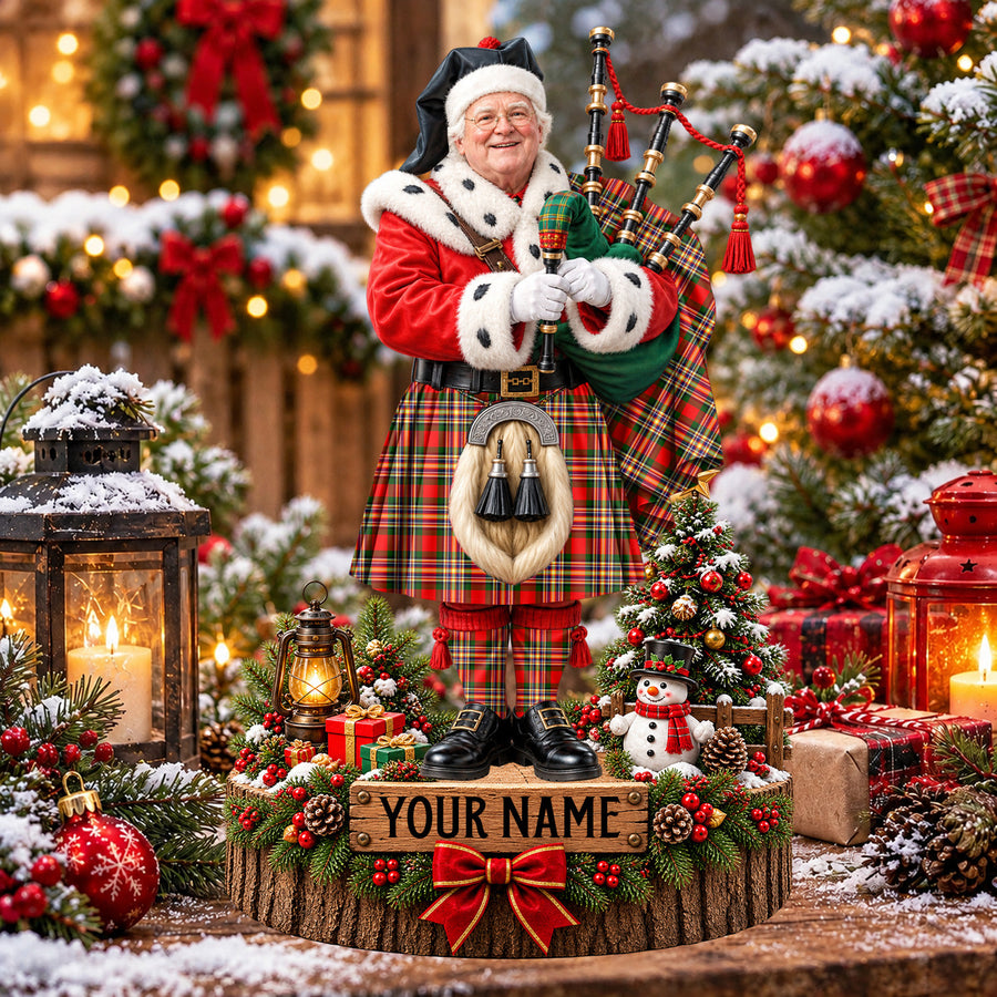 Personalized Christmas piper plaque in the MacGill Modern tartan, standing on a snowy log base with a name plaque